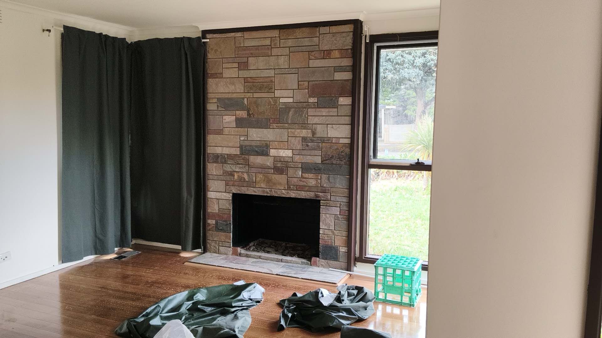 Ellis Services curtain installation in progress around a fireplace